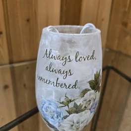 Decorative memorial candle holder with floral print and the words "Always loved, always remembered."