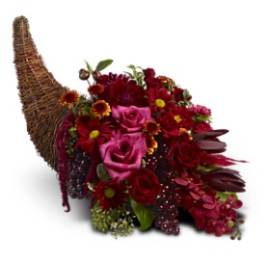 Horn-shaped basket filled with red and pink flowers
