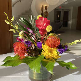 Colorful tropical flower arrangement in a glass vase