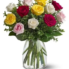 Bouquet of multicolored roses in a clear glass vase
