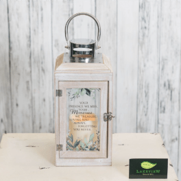 Wooden memorial lantern with a metal handle and printed sympathy message