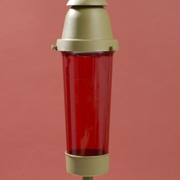 Red glass memorial candle lantern with a cross topper