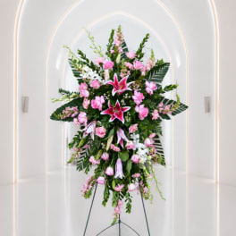 Tall pink and white floral standing spray on an easel