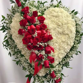 Heart-shaped floral spray with red roses and white flowers