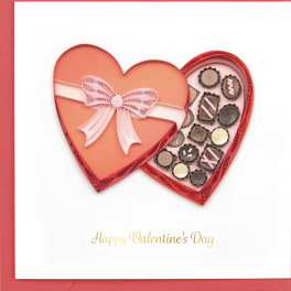 Heart-shaped Valentine card with a pink bow and small paper quilled hearts