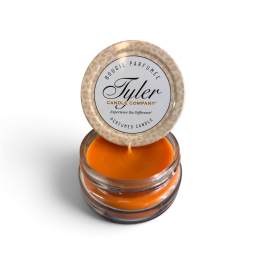 Orange scented candle in a glass jar with a leopard-print lid