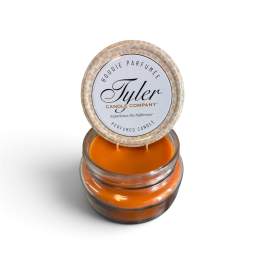 Orange scented candle in a glass jar with a printed lid