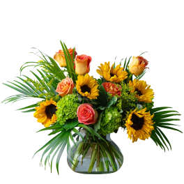 Sunflowers and peach roses arranged in a glass vase