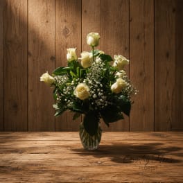 White roses arranged in a clear glass vase