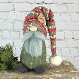 Small gnome figurine with a striped knit hat and fluffy beard