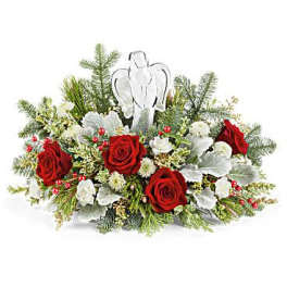 Red roses and white flowers arranged with an angel ornament