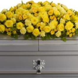 Yellow floral spray on a silver casket