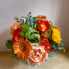 Bright mixed flower bouquet in a clear glass vase