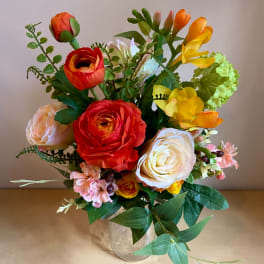Mixed bouquet of colorful flowers in a clear glass vase