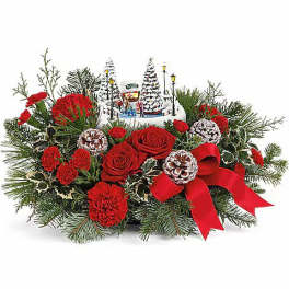 Christmas floral centerpiece with red roses and carnations, pine, and a red ribbon