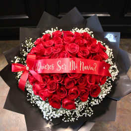 Bouquet of red roses with white baby's breath and a red ribbon