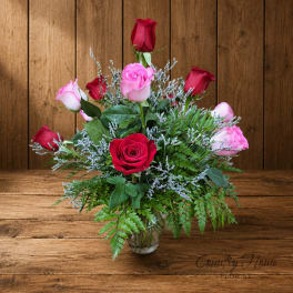 Bouquet of red and pink roses in a clear glass vase