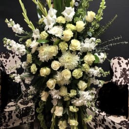 Tall white and pale yellow floral arrangement on a stand