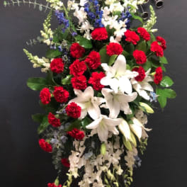 Standing floral spray with red carnations and white lilies