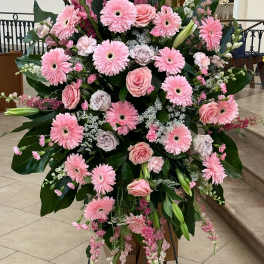 Large pink floral standing spray with gerbera daisies and roses