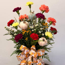 Fall bouquet with carnations, small daisies, pumpkins, and a pumpkin ribbon