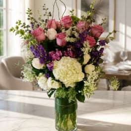 Pink roses and white hydrangeas in a clear glass vase