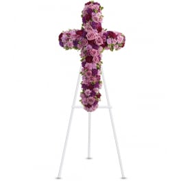 Purple and pink floral cross on a white easel