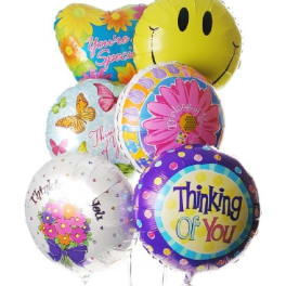 Cluster of colorful foil balloons with smiley and thank-you messages
