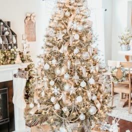 Decorated Christmas tree with gold and white ornaments and wrapped gifts