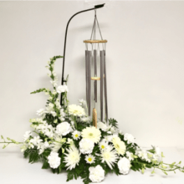 White floral arrangement with hanging wind chimes