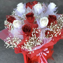 Bouquet of red and white roses wrapped in red and lavender mesh
