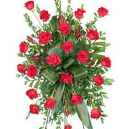 Standing spray of red roses on a metal easel