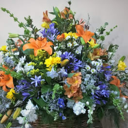 Large mixed bouquet with orange lilies, purple flowers, and yellow blooms