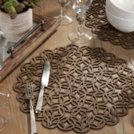 Table setting with glassware, plates, and a small potted succulent centerpiece