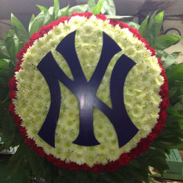 Round floral wreath with a blue Yankees logo in the center
