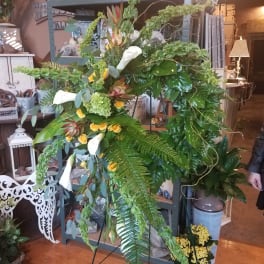 Large standing floral spray with white calla lilies and yellow roses