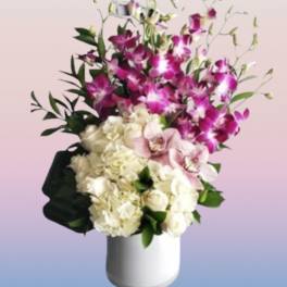 Pink orchids and white hydrangeas in a white vase