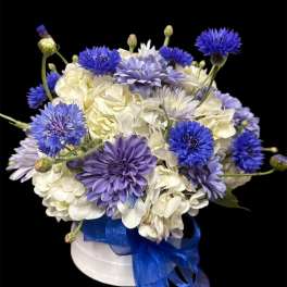 Blue and white bouquet in a white hat box with a blue ribbon