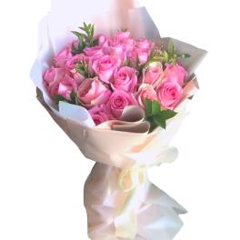 Bouquet of pink roses wrapped in white paper