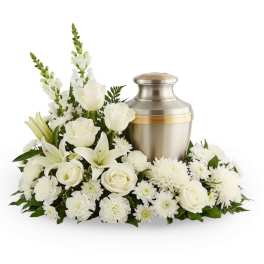 White floral arrangement with an urn-shaped metal keepsake