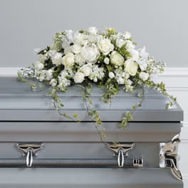 White floral spray on a silver casket