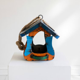 Painted wooden birdhouse with a rope hanger