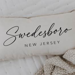 Cream pillow with the word "Swedesboro" printed on it