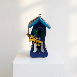 Blue wooden birdhouse with painted butterfly decorations