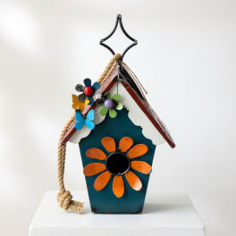 Decorative birdhouse with painted flowers and a rope hanger