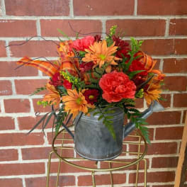 Fall flower arrangement in a metal watering can