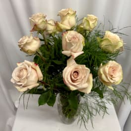 Bouquet of pale blush roses in a clear glass vase