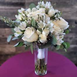 White rose bouquet in a clear glass vase