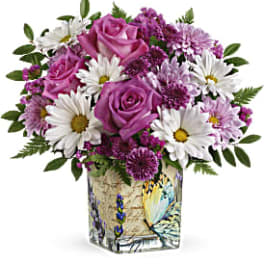 Pink roses and white daisies in a decorative square vase