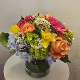 Colorful mixed flower arrangement in a glass vase